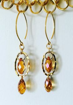 Elegant, minimalist cognac, floating faceted crystal pendant earrings. Handmade 24k gold vermeil over sterling silver findings with Swarovski Crystal Teardrop elements on horse eye ear wires. Lightweight, elegant ear candy with a pop of floating crystal magic. Love creating with Swarovski elements! ♥️  Uniquely designed by me!💎 Thanks for stopping by! 🙏🌸 Elegant Gold Faceted Crystal Earrings, Gold Faceted Crystal Earrings For Gift, Gold Faceted Crystal Earrings For Anniversary, Gold Faceted Drop Earrings, Gold Faceted Dangle Crystal Earrings, Gold Drop Earrings With Faceted Details, Modern Gold Briolette Earrings, Gold Faceted Earrings For Anniversary, Nickel-free Gold Drop Crystal Earrings