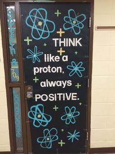 a door decorated with the words think like a proton, always positive