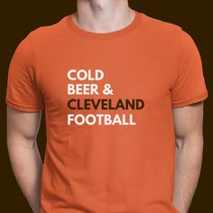 a man wearing an orange shirt with the words cold beer and cleveland football on it