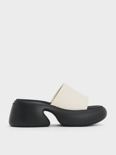 The chalk-white straps of these platform mules create a striking visual contrast against the black bottoms. Despite their simple aesthetic, they make a bold statement. The 7cm platform soles, elegantly curved to give off a sculptural effect, offer a substantial height boost without compromising comfort. Crafted from silk, these shoes offer breathability and are cool to the touch, making them particularly desirable during the warmer spring and summer months. Belt Ring, Platform Mules, Simple Aesthetic, Size Chart For Kids, Warm Spring, Chalk White, Wallet Gifts, Charles Keith, Black Platform