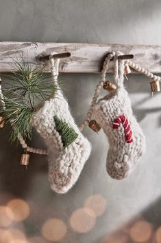 two christmas stockings hanging from a wooden rack