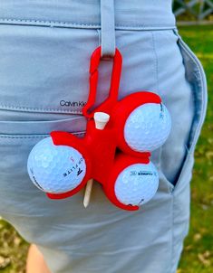 a golf ball holder attached to the back of a man's pants