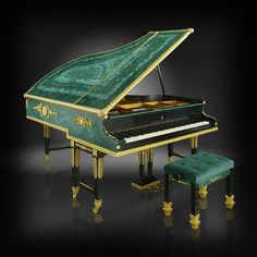 a grand piano with a green velvet case and gold trimmings on the legs