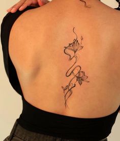 the back of a woman's shoulder with flowers and vines on her left side