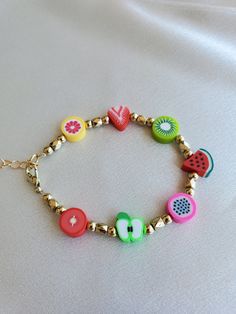 a colorful bracelet with fruit charms on it