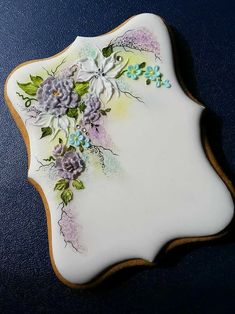 a white plate with purple flowers on it