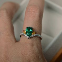 This ring features a lab emerald ,and sterling silver finished with rhodium. Customization is available. It is made by hand, and it will take about 7 days to finish the ring after your payment is completed. Main stone: lab emerald Metal type: sterling silver finished with rhodium Accent stone: citrine Customization is available, I also can make it with 14k solid gold (white or yellow or rose) and diamond accent stone, just feel free to contact me. Any question, just let me know. :) My shop homep Rings Emerald, Cut Rings, Rings Green, Original Engagement Rings, Pear Cut Ring, Emerald Wedding Rings, Pear Cut Engagement Rings, Emerald Rings, Memorial Ring