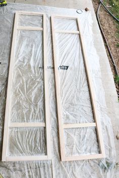 two pieces of wood sitting on top of a tarp