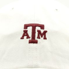 This is a super cute yet simple way to show off your A&M spirit. This is a white hat with a small logo of A&M in maroon on the front. It is perfect to keep you cooled off and goes with just about anything! White Snapback Hat For Fan Gear, Casual White Dad Hat With Flat Bill, White Collegiate Snapback Hat, White Curved Brim Trucker Hat For College, White Collegiate Cap, White Snapback Fitted Hat For Game Day, White Sporty Dad Hat With Flat Bill, White Flat Brim Baseball Cap For Game Day, White Flat Bill Hats For Game Day