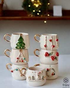 four coffee mugs with christmas decorations on them