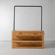 a wooden chest with two drawers and a metal handle on the top, against a gray background