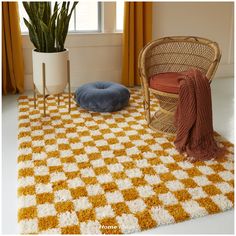 a yellow and white checkered rug with a round pillow on the floor next to it