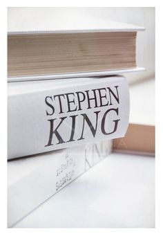 a stack of books sitting on top of a white table