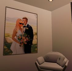 a room with a couch, chair and photo on the wall in front of it