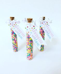 three bottles filled with sprinkles and confetti