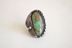 "This Native American ring features a large green turquoise stone in a large statement setting. The ring is in good condition with natural aged patina. Turquoise stone has an inclusion that is natural to the stone. Ring is signed \"B Sterling\" - possible Benjamin Piaso Navajo. Please checkout the similar turquoise stone cuff - different artisan - (ring and cuff are listed separately). size 7 1/2 1 5/8 inch tall 1 3/16 inch wide band is 1/2 to 3/4 inch thick I ship worldwide! Thanks for looking.