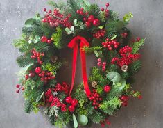 a christmas wreath with red berries and greenery