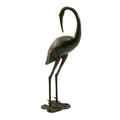 a bronze statue of a flamingo on a white background