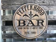 a wooden sign that says pepper hood bar