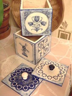 three decorative boxes sitting on top of a table