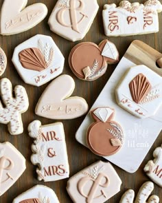 wedding cookies are arranged on a table with the bride and groom's names written on them