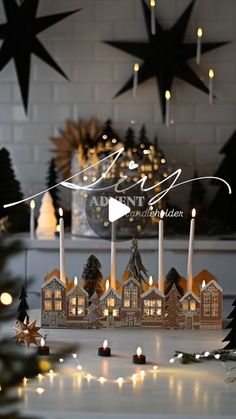 a christmas scene with lit candles and small houses