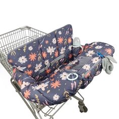 a baby seat in a shopping cart with flowers on it's back and wheels