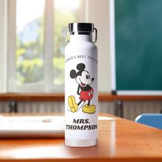 a water bottle sitting on top of a wooden desk