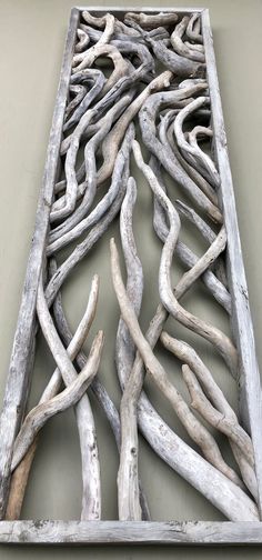 an artistic piece of driftwood is displayed on the wall