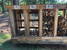 two stacks of wood stacked on top of each other in front of a pile of logs