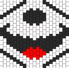 a cross stitch pattern that looks like the face of an evil looking person with red eyes