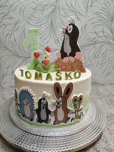 a cake decorated with cartoon characters and the number one