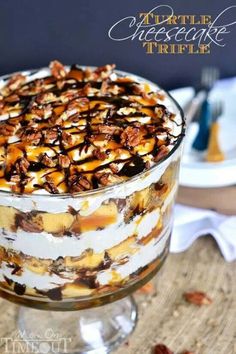 a trifle with nuts and cream in a glass dish on top of a table