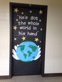 a door decorated with the words he's got the whole world in his hand