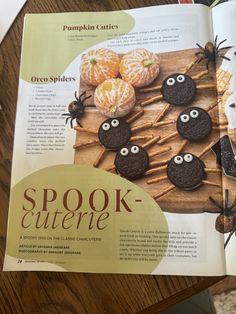 an open magazine about halloween cookies with googly eyes and spider webs on them