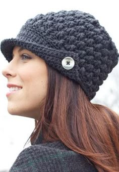 a woman with red hair wearing a black crochet hat