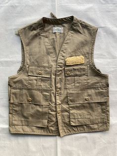 "Vintage 1980's SafTbak Fishing Vest In Very Good Condition, Have a bit stain, No have Damaged, Made in USA, So many pockets, Good materials, And game bag back, Mens Size L * Size Measurement * (Inches) Shoulder 18\" Pit to Pit 23\" Length 25.5\"  Return & Exchange no Accepted" Ootd Vest, Photographer Vest, Lauren Lewis, Safari Vest, Safari Outfits, Swedish Army, Fishing Vest, Khaki Trousers, Work Trousers