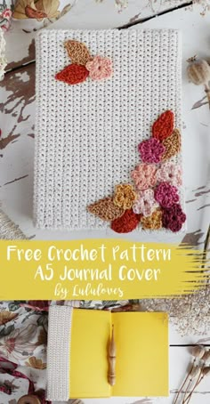 the crochet pattern for a journal cover is shown with flowers and leaves on it