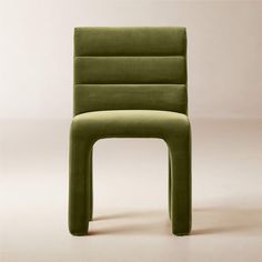 a green chair sitting on top of a white floor