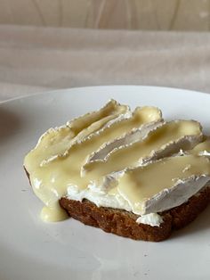 a piece of cake with icing sitting on top of a white plate