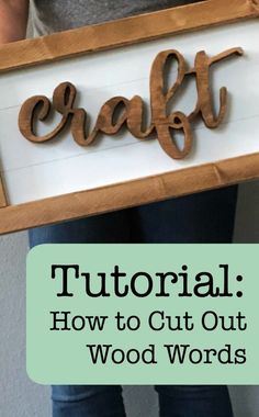 a person holding a sign that says craft with the words how to cut out wood words