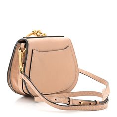 This is an authentic CHLOE Calfskin Suede Small Nile Bracelet Bag in Biscotti Beige. This chic crossbody is crafted of fine calfskin leather in pink. The bag has an aged gold loop handle, an optional leather shoulder strap, and aged gold hardware. The flap opens to a beige suede interior with a patch pocket. Bracelet Bag, Gold Hardware, Patch Pocket, Calf Skin, Chloe, Shoulder Strap, Bracelet, Leather, Pink