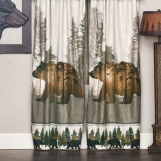 two bears are standing in front of the window with trees and pine cones on it