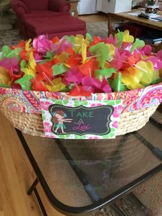 a basket filled with colorful streamers on top of a table