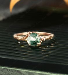 a green ring sitting on top of a black grill with an orange object in the background