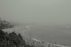 black and white photograph of the beach in fog