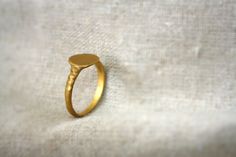 a gold ring sitting on top of a white cloth