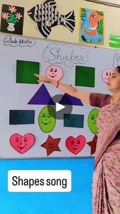 a woman standing in front of a whiteboard with pictures on it and writing shapes