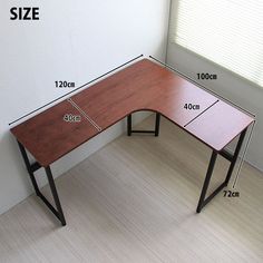 a wooden desk with measurements for the top and bottom section, in front of a white wall