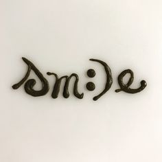 the word ome written in cursive black ink